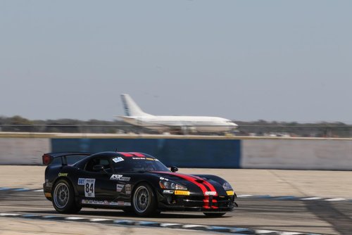 A picture of a black car on a racetrack 