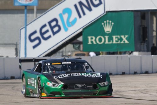 A picture of a black and green Ford Mustang