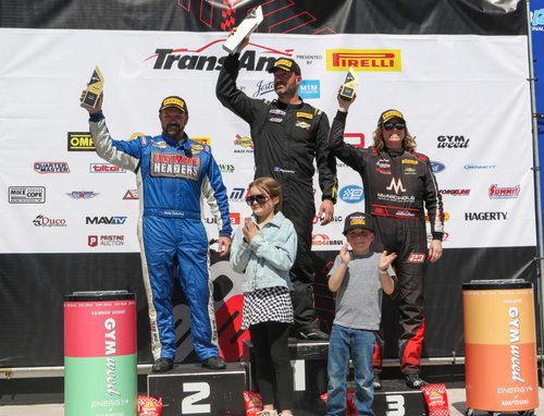 A picture of the Trans Am Series finalists with two children clapping