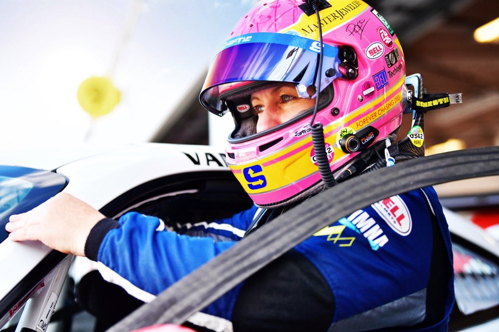 A picture of Pippa Mann wearing a pink helmet